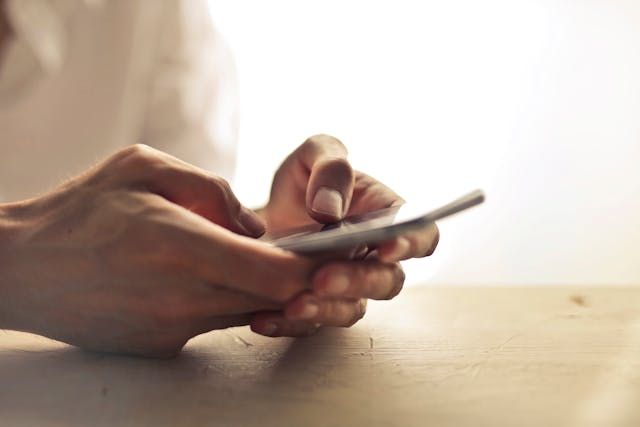 Holding a cell phone with both hands